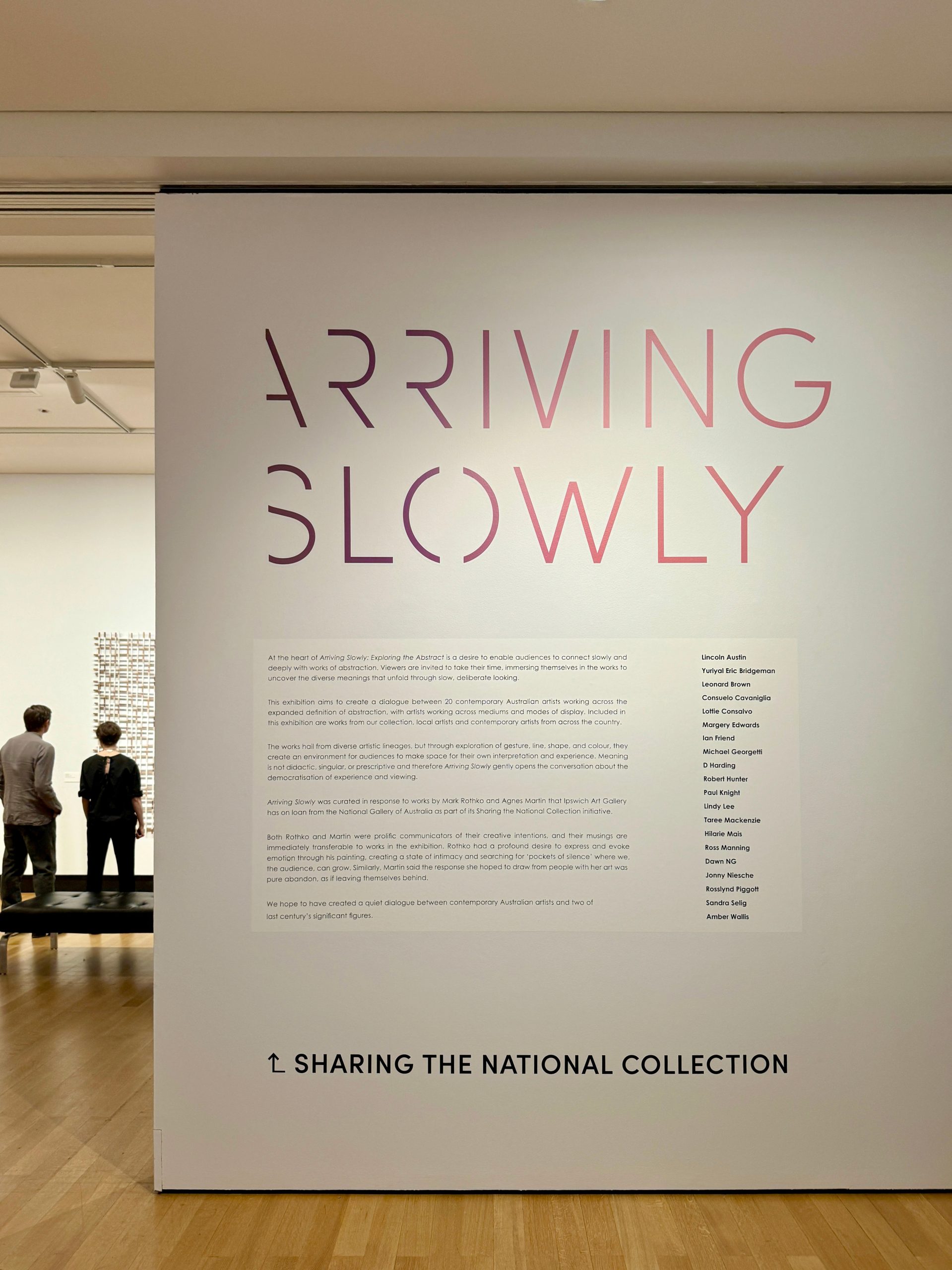 Arriving Slowly exhibition title wall text and graphics